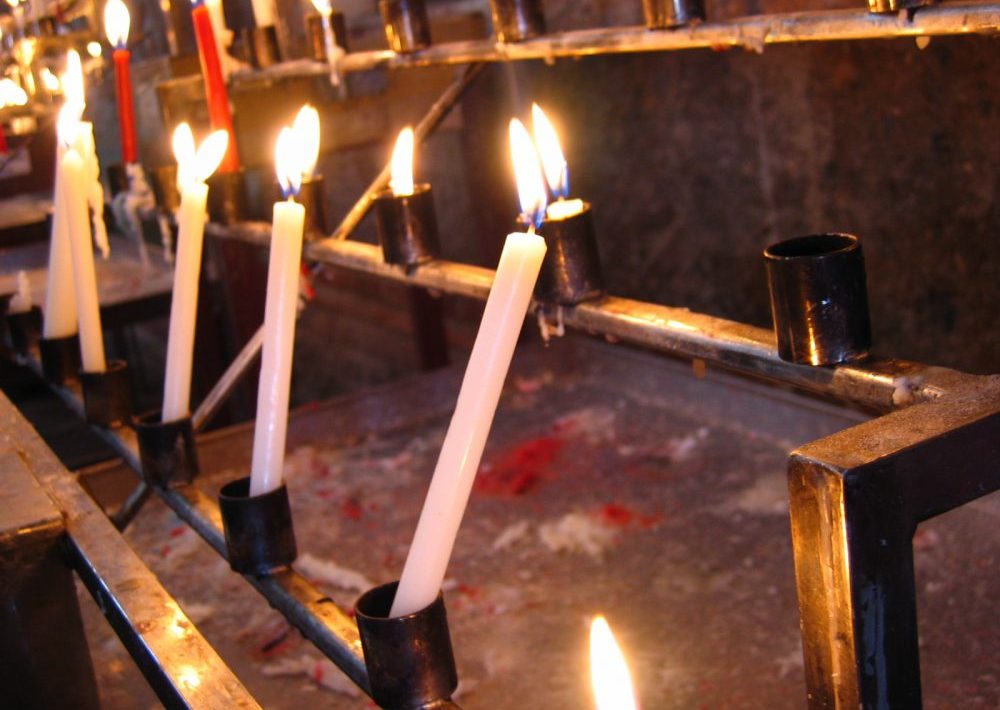 Lit church candles in memory of a deceased person
