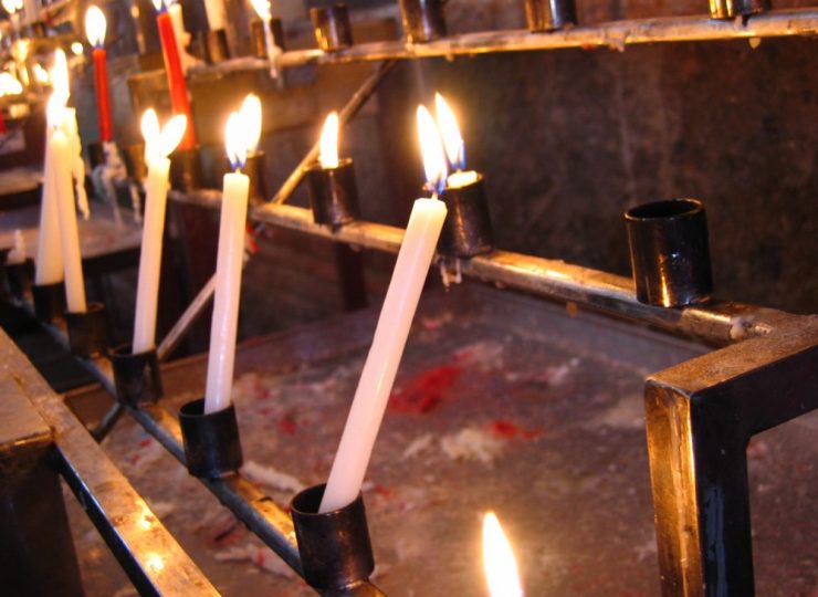 Lit church candles in memory of a deceased person